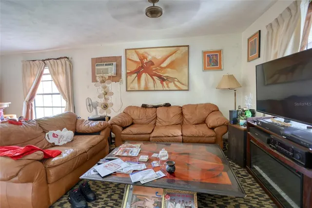 a living room with furniture fireplace and window