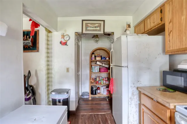 a kitchen with stainless steel appliances granite countertop a refrigerator and a stove