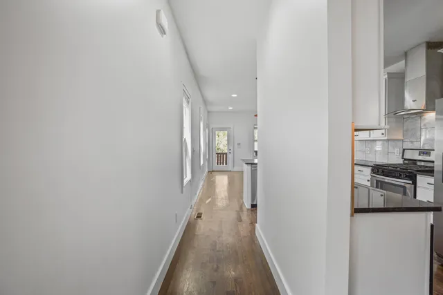 a view of hallway with wooden floor