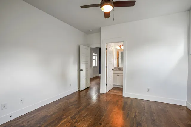 a view of an empty room and wooden floor