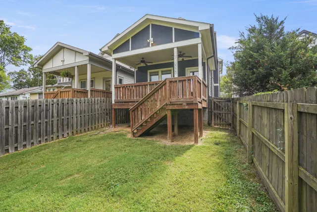 a view of a house with a yard and deck