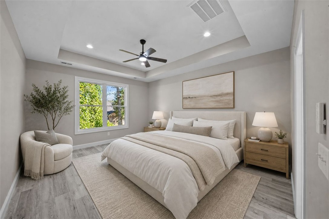 105 Bree Drive Anderson, SC 29621 - Photo 5 of 48 Recessed lighting and a ceiling fan illuminate this inviting bedroom, featuring a tray ceiling and durable flooring.