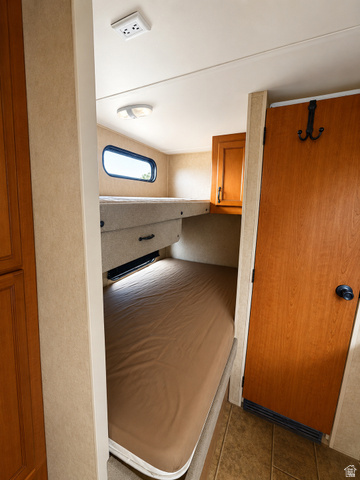 347 East North Old Summit Road Monticello, UT 84535 - Photo 29 of 30 Built-in bunk beds in travel trailerwith integrated lighting, wood-finish cabinetry, and a privacy door
