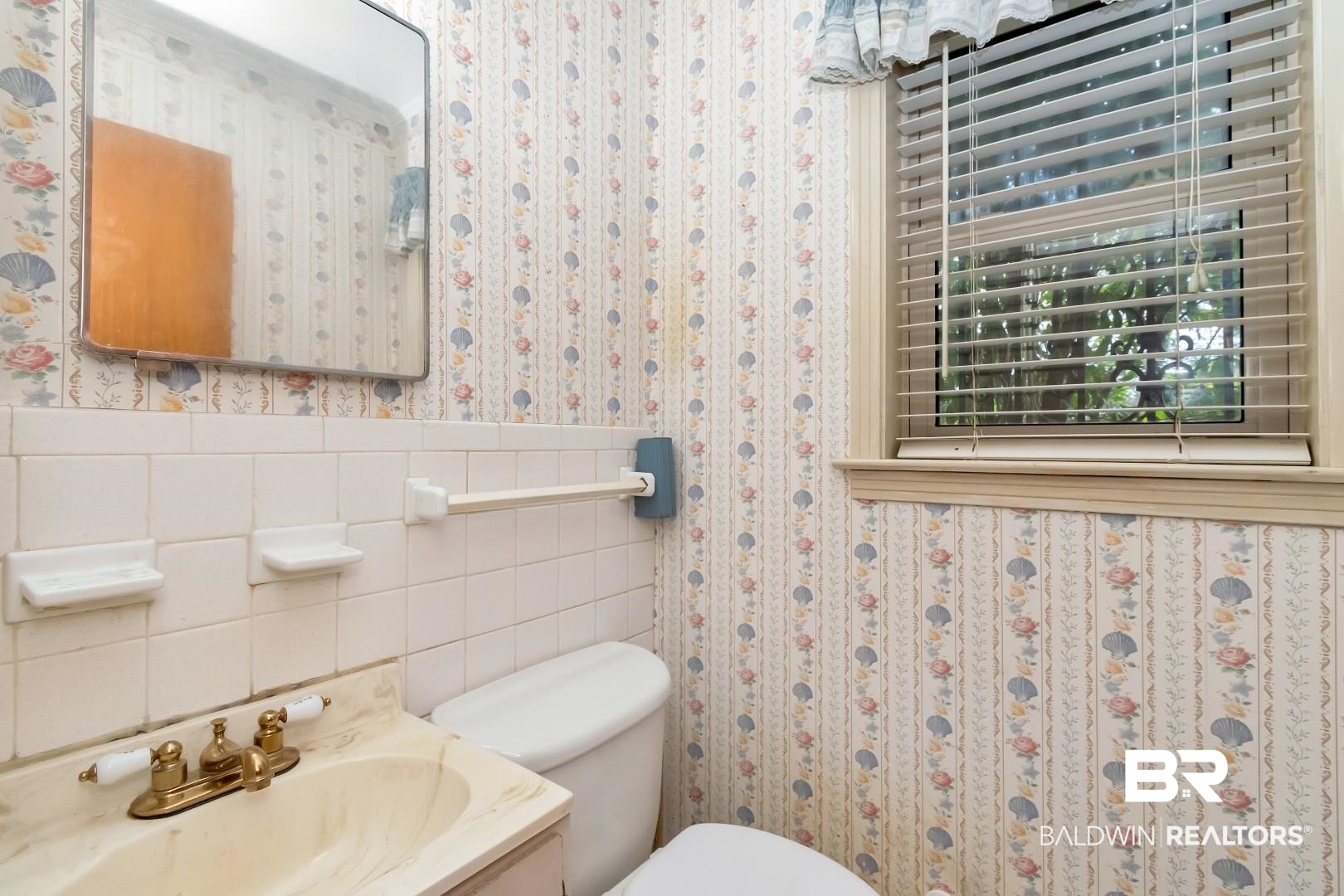 3715 South Conway Drive Mobile, AL 36608 - Photo 13 of 24 Half bathroom featuring tile walls, a wainscoted wall, wallpapered walls, and toilet