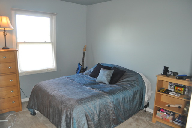 127 Barnes Road Elgin, IL 60124 - Photo 13 of 19 a bed sitting in a bedroom next to a window