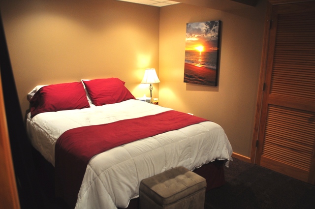 127 Barnes Road Elgin, IL 60124 - Photo 17 of 19 a bedroom with a bed and a lamp