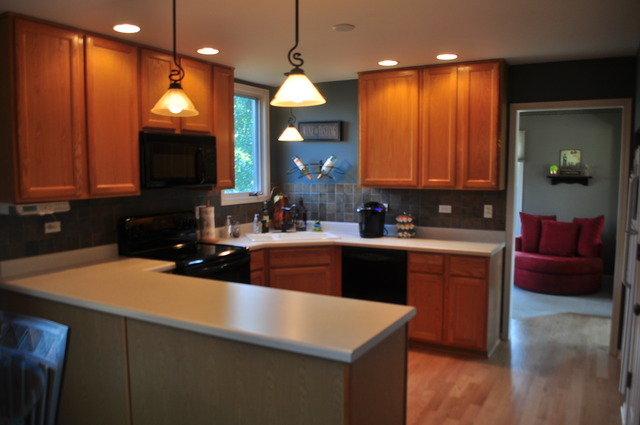 127 Barnes Road Elgin, IL 60124 - Photo 3 of 19 a kitchen with a sink a counter space and a fireplace