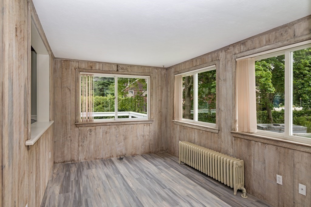 24 Main Street Hull, MA 02045 - Photo 11 of 19 an empty room with wooden floor and windows