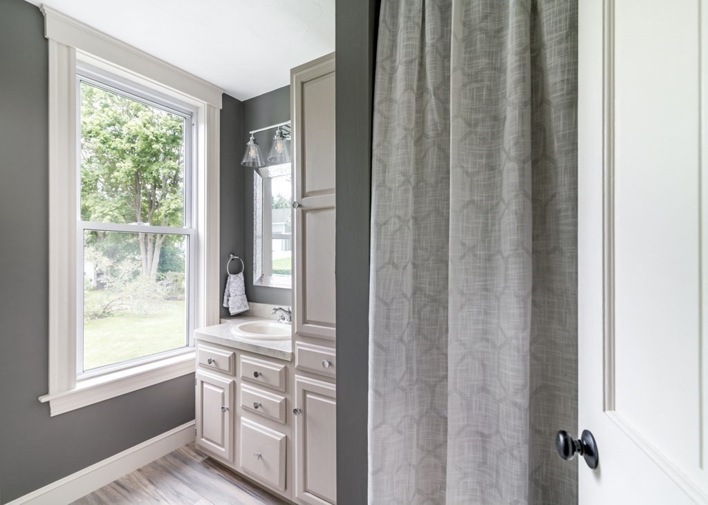 24 Main Street Hull, MA 02045 - Photo 16 of 19 a kitchen with white cabinets and sink