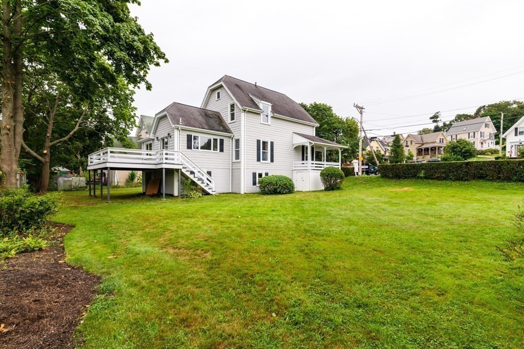 24 Main Street Hull, MA 02045 - Photo 18 of 19 a front view of a house with a garden and trees