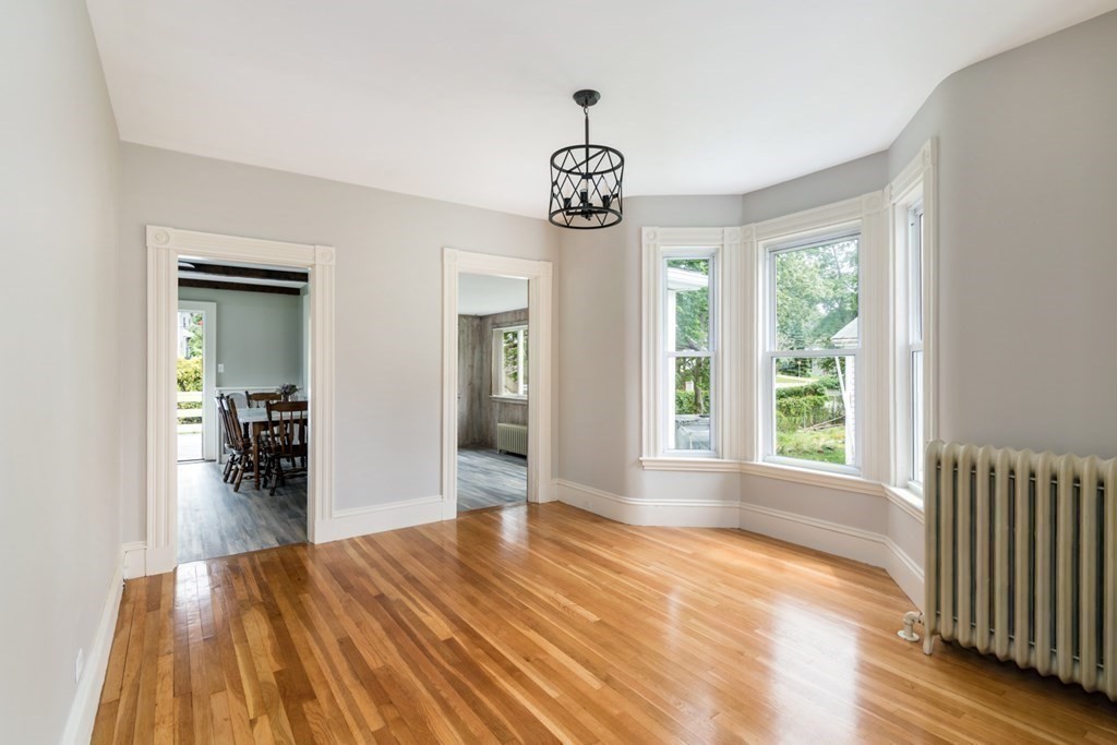 24 Main Street Hull, MA 02045 - Photo 8 of 19 a view of empty room with wooden floor and fan