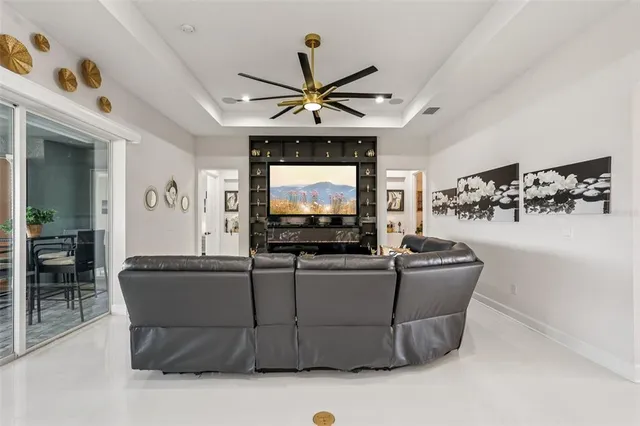 a bedroom with a bed and a flat tv screen on dresser