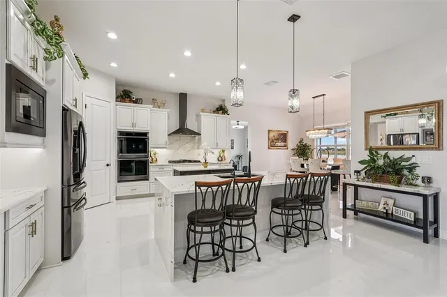 a kitchen with table chairs and stove top oven