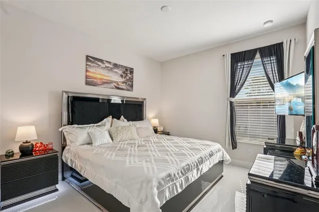 a front view of a house with a garden and trees