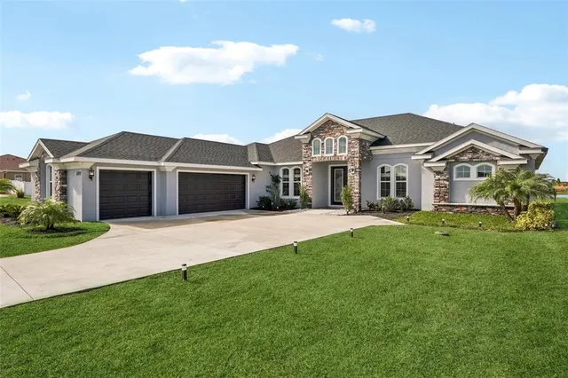 a living room with furniture a chandelier and a large window