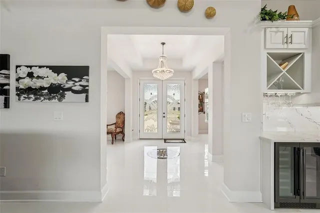 a view of a dining room with furniture and chandelier