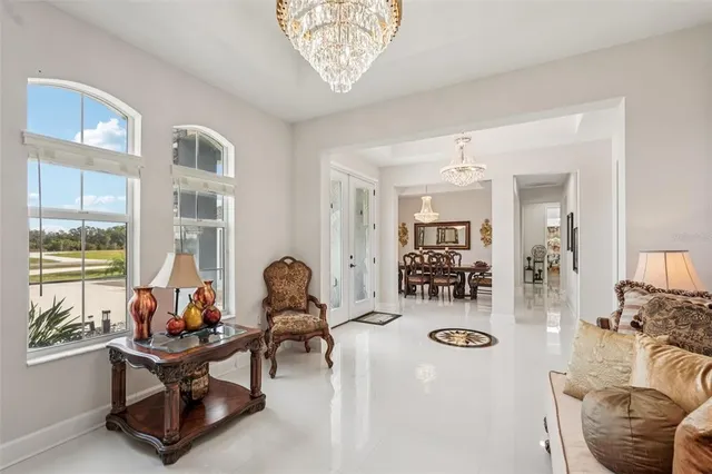 a view of a a dining room with furniture window and wooden floor