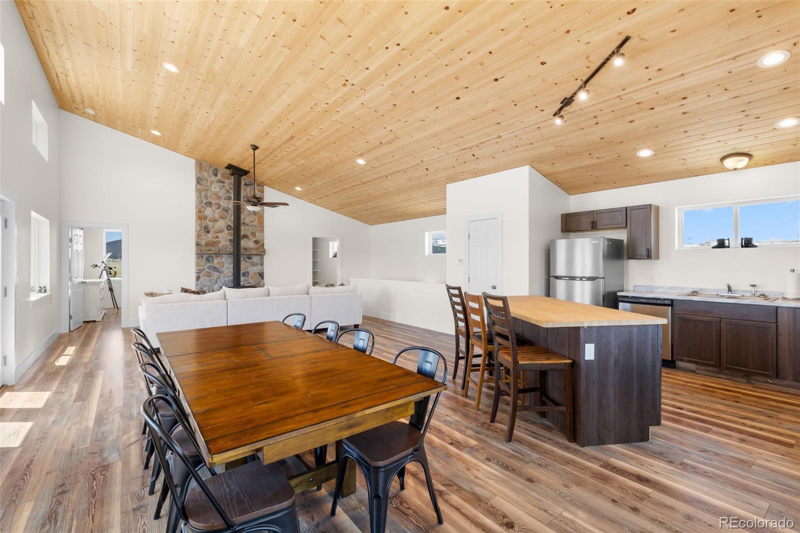 431 Rudisill Street Fairplay, CO 80440 - Photo 12 of 48 a dining hall with stainless steel appliances a dining table chairs with wooden floor
