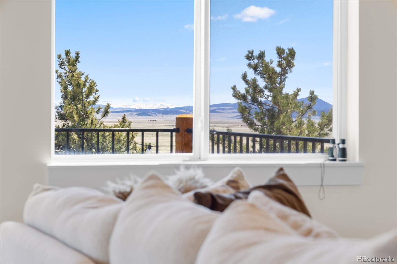 431 Rudisill Street Fairplay, CO 80440 - Photo 7 of 48 a bed sitting in a bedroom next to a window with potted plants