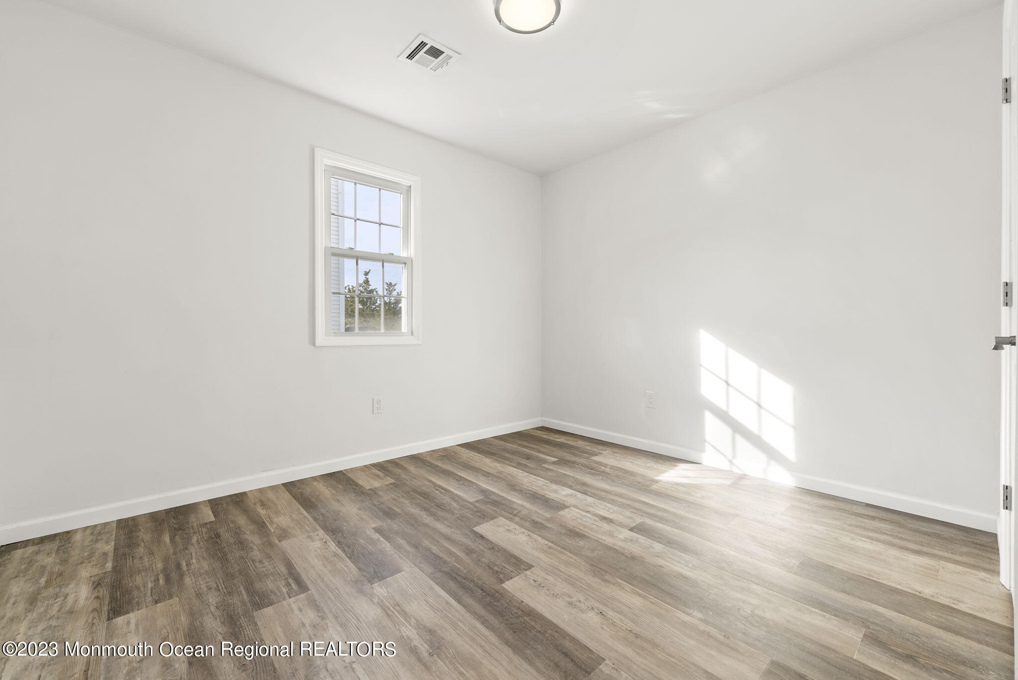3 Hickory Hill Road Toms River, NJ 08753 - Photo 18 of 27 an empty room with wooden floor and windows