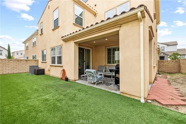 a view of a house with a yard and sitting area