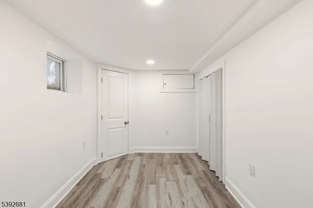 a view of an empty room with wooden floor