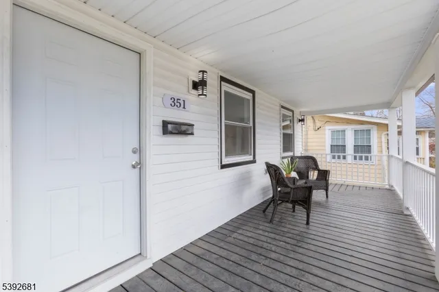 a view of a livingroom with lounge chair and a window