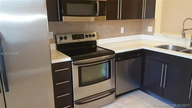a kitchen with a stove microwave and sink