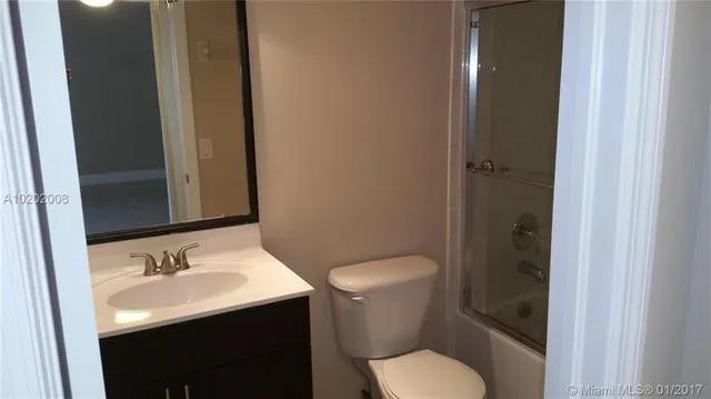a bathroom with a sink toilet and vanity