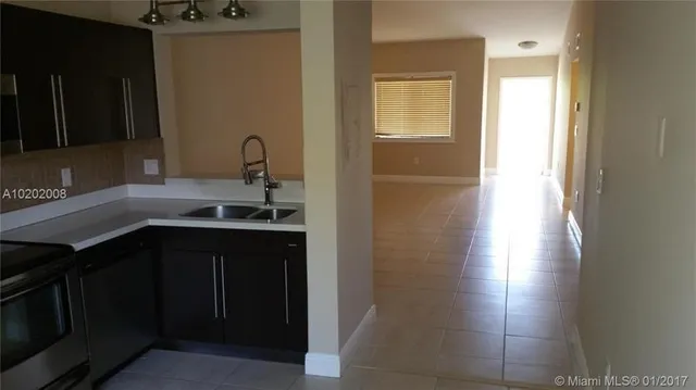 a kitchen with a sink and a window
