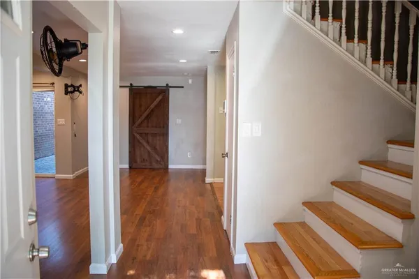 a view of hallway with wooden floor