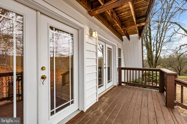 a big room with wooden floor and windows