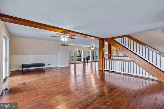 a view of a workspace with furniture and wooden floor