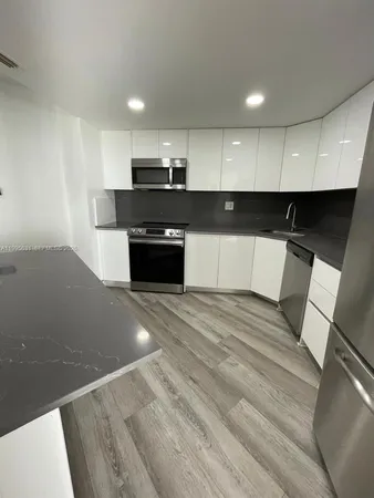 a kitchen with stainless steel appliances wooden cabinets and granite counter tops