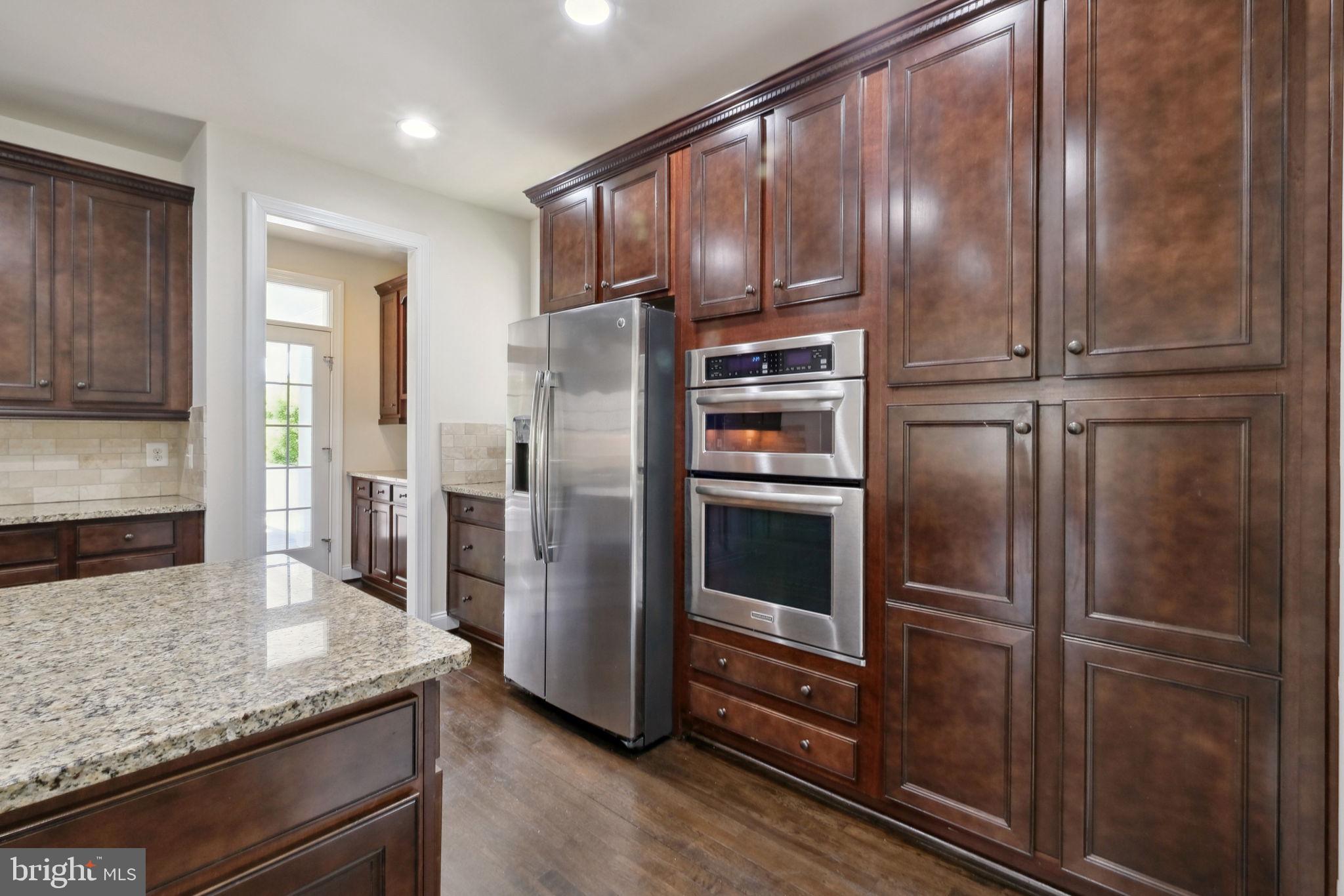 13501 Moonlight Trail Drive Silver Spring, MD 20906 - Photo 16 of 77 a kitchen with stainless steel appliances granite countertop a refrigerator and a sink