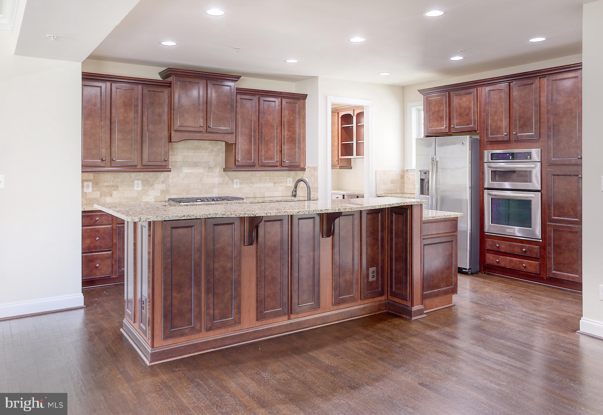 13501 Moonlight Trail Drive Silver Spring, MD 20906 - Photo 19 of 77 a kitchen with stainless steel appliances granite countertop wooden cabinets a sink and dishwasher