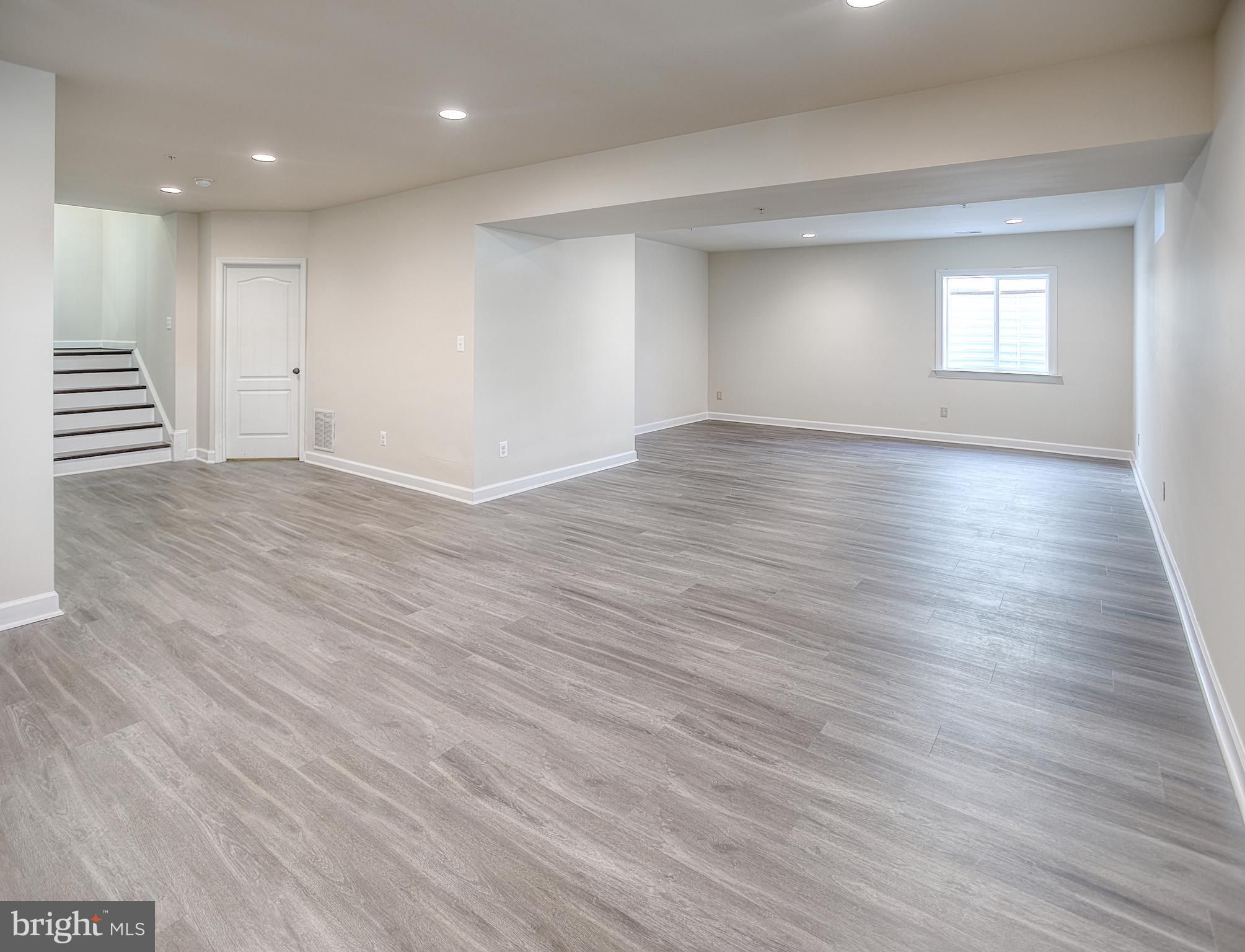 13501 Moonlight Trail Drive Silver Spring, MD 20906 - Photo 57 of 77 a view of empty room with wooden floor and window