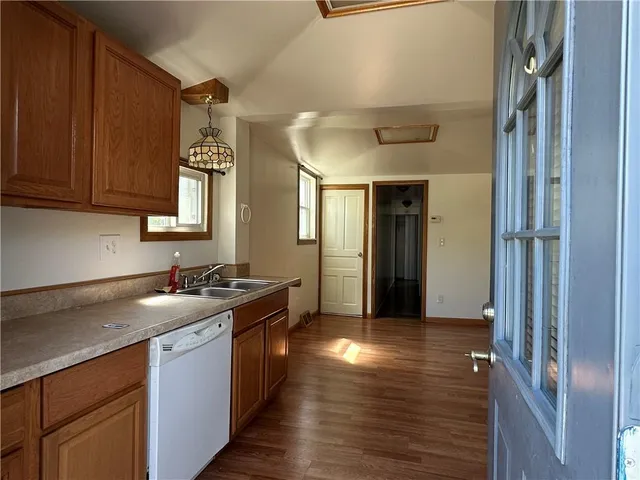 a kitchen with granite countertop a sink and cabinets