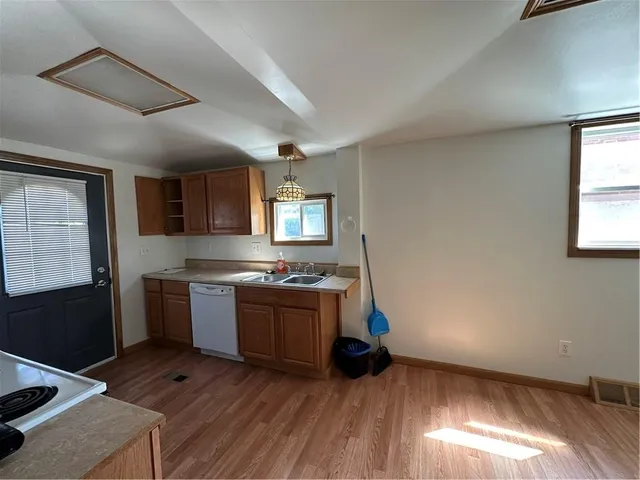 a kitchen with a sink and a stove top oven