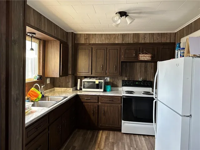 a kitchen with a sink a stove and refrigerator