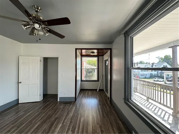 wooden floor in an empty room with a window