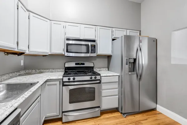 a kitchen with a stove microwave and a refrigerator