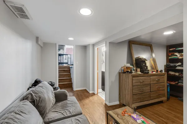 a living room with furniture and wooden floor