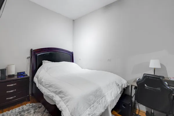 a bedroom with a bed and a desk