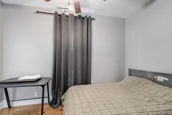 a bedroom with a bed and a table