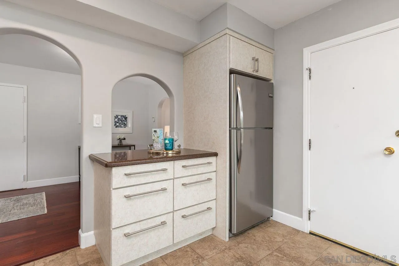 2362 Torrey Pines Road, Unit 33 La Jolla, CA 92037 - Photo 10 of 32 a kitchen with a refrigerator and cabinets