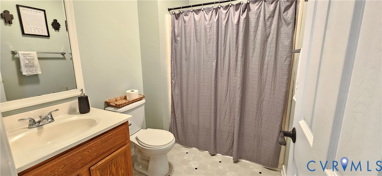 2239 Mantapike Landing Road Stevensville, VA 23161 - Photo 12 of 22 a white toilet sitting next to a bathroom sink