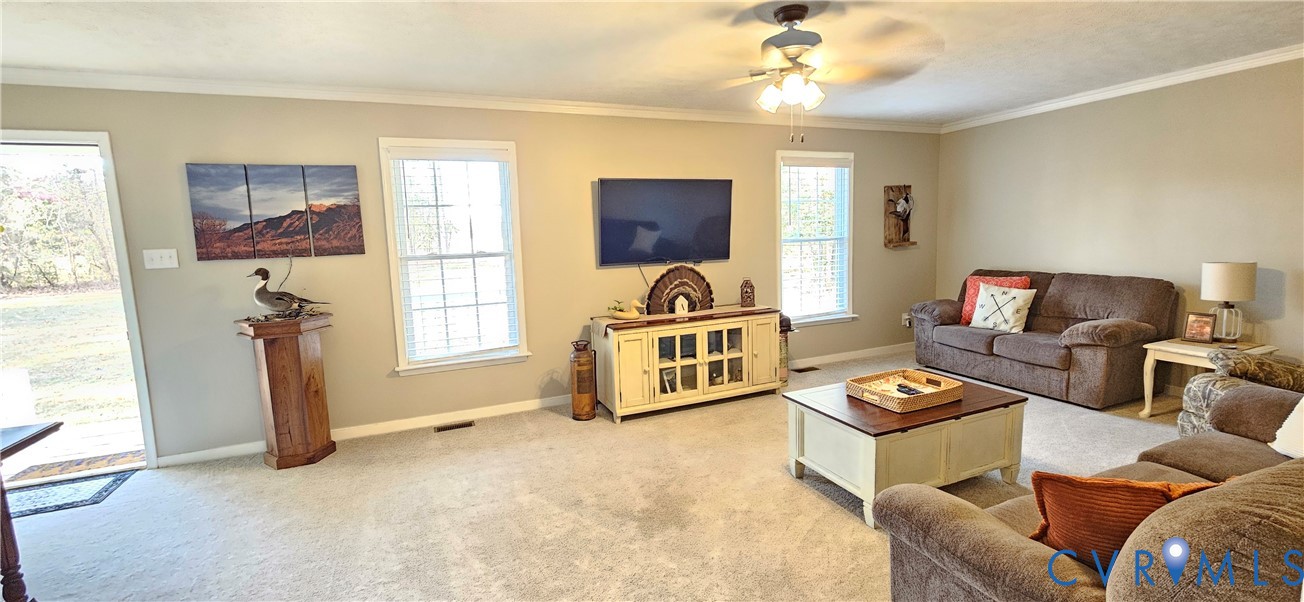 2239 Mantapike Landing Road Stevensville, VA 23161 - Photo 7 of 22 a living room with furniture a flat screen tv and a window