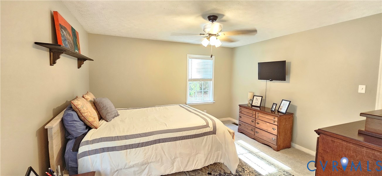 2239 Mantapike Landing Road Stevensville, VA 23161 - Photo 8 of 22 a bedroom with a bed and a flat screen tv