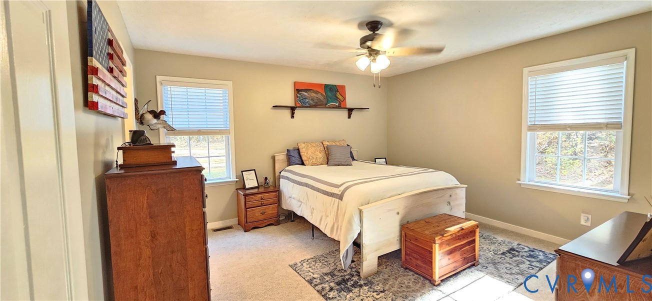2239 Mantapike Landing Road Stevensville, VA 23161 - Photo 9 of 22 a bedroom with a bed and wooden floor
